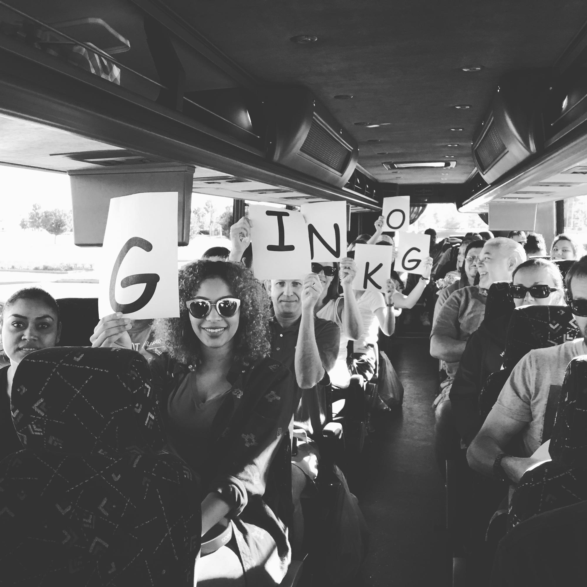 Ginkgo Residential | People Holding Up Signs in a Bus That Spell Out Ginkgo